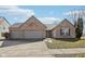 Charming brick home featuring an attached two-car garage and manicured front yard at 8535 Fenton Tower Dr, Indianapolis, IN 46259