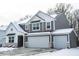Two-story home with gray siding, white trim, two-car garage, and snow-covered roof and yard at 8623 Lester Pl, Pendleton, IN 46064