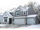 Two-story home with gray siding, white trim, two-car garage, and snow-covered roof and yard at 8623 Lester Pl, Pendleton, IN 46064