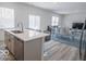 Bright, open-concept kitchen with stainless steel appliances and a large island countertop at 8623 Lester Pl, Pendleton, IN 46064