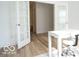 Bright office space with white french doors, a white desk, a rolling chair, and hardwood floors at 8623 Lester Pl, Pendleton, IN 46064