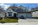 Charming two-story home with a three car garage, lush green lawn and grey exterior paint at 8623 Lester Pl, Pendleton, IN 46064