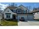 Charming two-story home featuring a three-car garage and a well-manicured lawn at 8623 Lester Pl, Pendleton, IN 46064