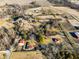An aerial shot with a yellow boundary line that shows homes amid trees and the property's boundaries at 1001 N 750 W, Bargersville, IN 46106