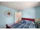 This bedroom features a sun decoration, blue walls, and a comfortable bed with a blue and white striped comforter at 1001 N 750 W, Bargersville, IN 46106