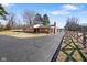 View of home's front exterior and long driveway, featuring stacked firewood on the porch at 1001 N 750 W, Bargersville, IN 46106