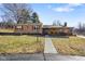 A charming single-story home featuring a well-maintained lawn and inviting front porch with stacked firewood at 1001 N 750 W, Bargersville, IN 46106