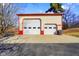Two-door garage with a red trim and white siding, perfect for storage or workshop, set on a concrete pad at 1001 N 750 W, Bargersville, IN 46106
