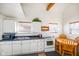 Well-lit kitchen featuring white cabinets, modern appliances, and a cozy dining area at 1001 N 750 W, Bargersville, IN 46106