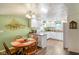 Open concept kitchen with dining area, white cabinetry, and hardwood floors at 1001 N 750 W, Bargersville, IN 46106