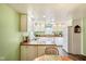 Bright kitchen with white appliances, white cabinets, and a view into the dining area at 1001 N 750 W, Bargersville, IN 46106