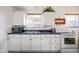 Well-lit kitchen with white cabinetry, wood-look blinds, and appliances at 1001 N 750 W, Bargersville, IN 46106