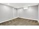 A finished basement features carpeted floors, ample lighting, and an alcove at 118 S 11Th Ave, Beech Grove, IN 46107