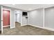 A finished basement features carpeted floors, ample lighting, and versatile living space at 118 S 11Th Ave, Beech Grove, IN 46107