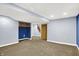 Basement featuring carpeted flooring, staircase, wood cabinets, and neutral-colored walls at 118 S 11Th Ave, Beech Grove, IN 46107