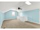A bright carpeted bedroom features blue walls, a ceiling fan, and a skylight at 118 S 11Th Ave, Beech Grove, IN 46107