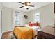 Serene bedroom with natural light from two windows, complemented by hardwood floors and cozy decor at 118 S 11Th Ave, Beech Grove, IN 46107