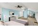 A spacious carpeted bedroom features blue walls, a ceiling fan, and a comfortable seating area at 118 S 11Th Ave, Beech Grove, IN 46107