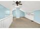 A carpeted bedroom features blue walls, a ceiling fan, and built-in storage cabinets at 118 S 11Th Ave, Beech Grove, IN 46107