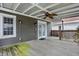 A covered deck provides an ideal outdoor retreat, complete with a ceiling fan and view of the backyard at 118 S 11Th Ave, Beech Grove, IN 46107