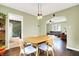 Dining area with hardwood floors, stylish chairs, and a view into the living room at 118 S 11Th Ave, Beech Grove, IN 46107