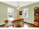 Bright dining area features hardwood floors, stylish seating, and natural light from the windows at 118 S 11Th Ave, Beech Grove, IN 46107