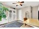 Charming home office is complete with french doors and a modern desk and rolling chair at 118 S 11Th Ave, Beech Grove, IN 46107