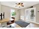 Bright and airy home office offers a ceiling fan, natural light and access to the outdoors at 118 S 11Th Ave, Beech Grove, IN 46107