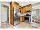 Well-lit kitchen features stainless steel appliances, ample wood cabinetry and tiled flooring at 118 S 11Th Ave, Beech Grove, IN 46107