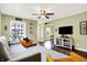 A bright living room with hardwood floors, comfortable seating, and a large window at 118 S 11Th Ave, Beech Grove, IN 46107