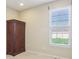 Bedroom with built-in wardrobe and a bright window with views of the neighborhood at 12880 Oxbridge Pl, Fishers, IN 46037