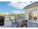 Outdoor deck with table and chairs overlooks a scenic lake with fountain and beautiful views at 12880 Oxbridge Pl, Fishers, IN 46037