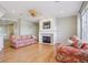 Comfortable living room with a fireplace, hardwood floors, and lots of natural light at 12880 Oxbridge Pl, Fishers, IN 46037