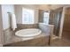 Bathroom featuring an oval tub, a separate shower, and a bright window at 12964 Walbeck Dr, Fishers, IN 46037