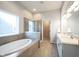 Bright bathroom features a soaking tub, tiled shower, and double sink vanity at 12964 Walbeck Dr, Fishers, IN 46037