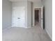Bright bedroom features neutral walls, plush carpeting, and a double-door closet for ample storage at 12964 Walbeck Dr, Fishers, IN 46037