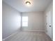 Bright, carpeted bedroom with a window providing natural light and a door leading to other areas at 12964 Walbeck Dr, Fishers, IN 46037