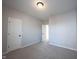 Carpeted bedroom with neutral walls, a window, and two doors for easy access to other areas at 12964 Walbeck Dr, Fishers, IN 46037
