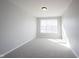 Bright bedroom with neutral walls, carpet, and a large window at 12964 Walbeck Dr, Fishers, IN 46037