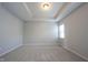 Neutral bedroom with carpet and tray ceiling, complemented by a bright window at 12964 Walbeck Dr, Fishers, IN 46037