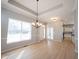 Dining room with hardwood floors offering views of the foyer and an adjacent modern kitchen at 12964 Walbeck Dr, Fishers, IN 46037