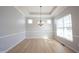 Open dining room with hardwood floors, tray ceiling, chandelier and lots of natural light at 12964 Walbeck Dr, Fishers, IN 46037