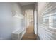 Bright entryway with natural light, light wood floors, and built-in storage bench and coat hooks at 12964 Walbeck Dr, Fishers, IN 46037
