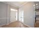Bright foyer with hardwood floors, white trim, and glass paneled doors leading to another room at 12964 Walbeck Dr, Fishers, IN 46037