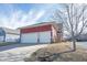 Exterior view of a home with an attached two-car garage, double driveway, and landscaped yard at 12964 Walbeck Dr, Fishers, IN 46037
