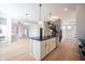 Open-concept kitchen with island, modern appliances, and adjacent living area, offering a spacious and connected living space at 12964 Walbeck Dr, Fishers, IN 46037