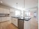 Island kitchen boasts stainless appliances, black countertop and white cabinetry at 12964 Walbeck Dr, Fishers, IN 46037