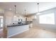 Bright kitchen showcases white cabinetry, pendant lighting, and a center island at 12964 Walbeck Dr, Fishers, IN 46037