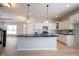 Spacious kitchen featuring an island with pendant lighting, stainless steel appliances, and ample cabinet space at 12964 Walbeck Dr, Fishers, IN 46037