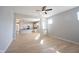 Bright, open-concept living room features hardwood floors and flows into a modern white kitchen at 12964 Walbeck Dr, Fishers, IN 46037